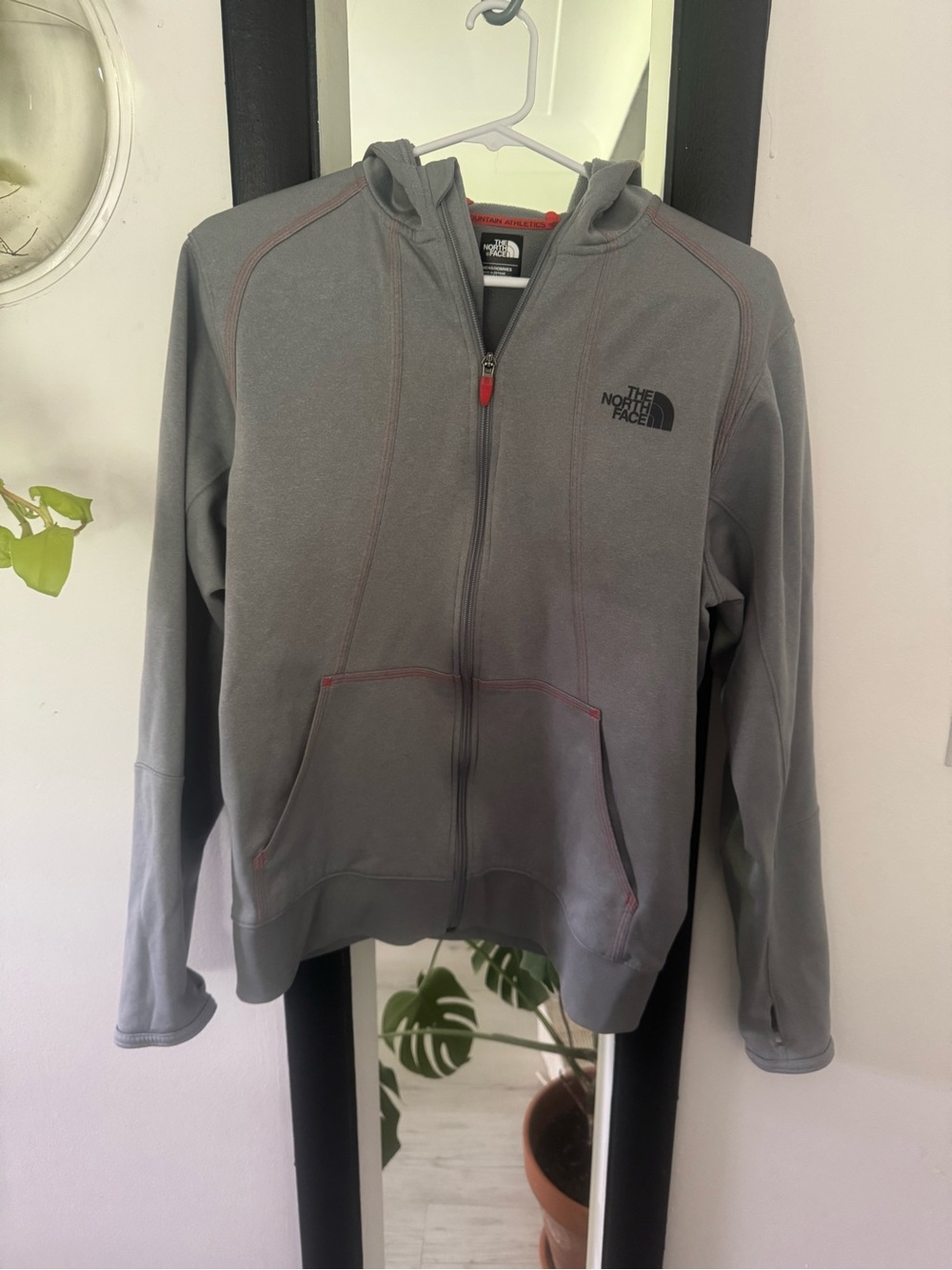 The North Face Gray Fleece Jacket with orange trim.